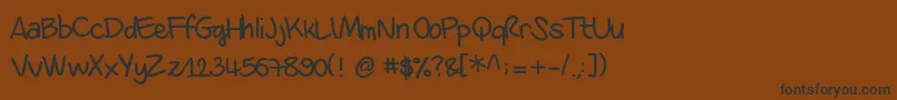 Danila-Schriftart – Schwarze Schriften auf braunem Hintergrund