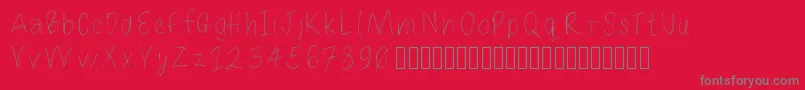 Loulousscribble-fontti – harmaat kirjasimet punaisella taustalla