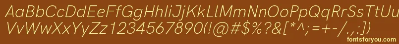 HkgroteskLightlegacyitalic-fontti – keltaiset fontit ruskealla taustalla