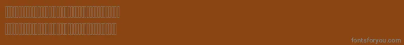 Czcionka AhmedOutlineLatinFigures – szare czcionki na brązowym tle