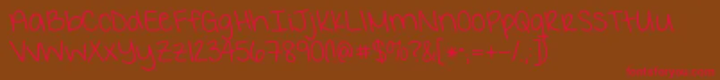 フォントKgIWantCrazy – 赤い文字が茶色の背景にあります。