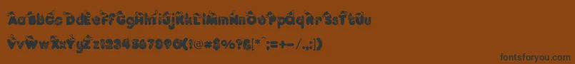 フォントKringleRegular – 黒い文字が茶色の背景にあります