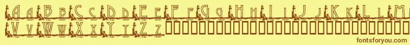 フォントKgGaylesLh – 茶色の文字が黄色の背景にあります。
