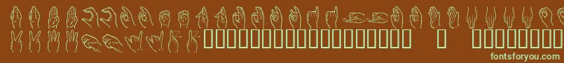 フォントHandsign – 緑色の文字が茶色の背景にあります。