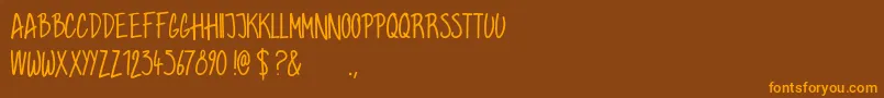フォントGrahamhand – オレンジ色の文字が茶色の背景にあります。