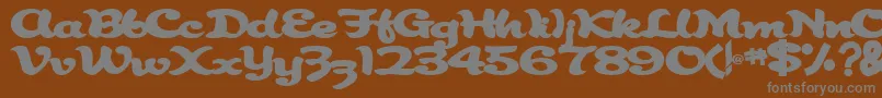 Abracadabra91Bold-fontti – harmaat kirjasimet ruskealla taustalla