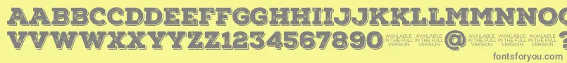 NexarustslabBlackshadow01-fontti – harmaat kirjasimet keltaisella taustalla