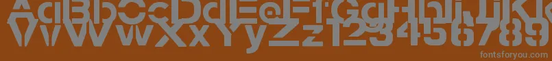 StampedNavyFontBold-fontti – harmaat kirjasimet ruskealla taustalla