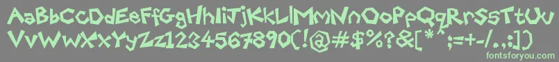 FreakyPaperCutouts-Schriftart – Grüne Schriften auf grauem Hintergrund