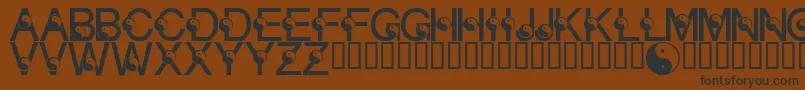 フォントLmsYingYang – 黒い文字が茶色の背景にあります