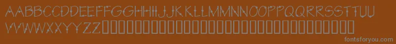KrCirkle-fontti – harmaat kirjasimet ruskealla taustalla