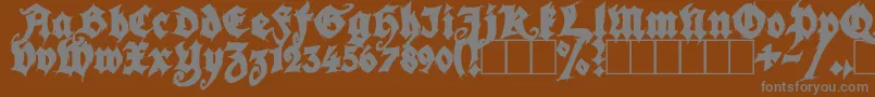 SeasonOfTheWitchBlack-Schriftart – Graue Schriften auf braunem Hintergrund