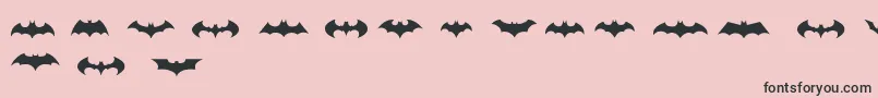 BatmanLogoEvolutionTfb-Schriftart – Schwarze Schriften auf rosa Hintergrund