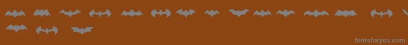 BatmanLogoEvolutionTfb-Schriftart – Graue Schriften auf braunem Hintergrund