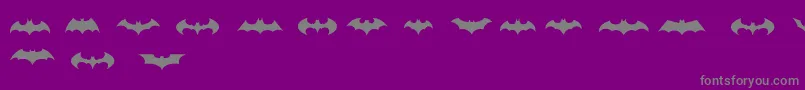 BatmanLogoEvolutionTfb-Schriftart – Graue Schriften auf violettem Hintergrund