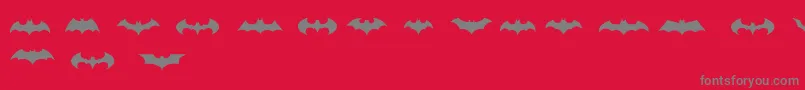 Fonte BatmanLogoEvolutionTfb – fontes cinzas em um fundo vermelho