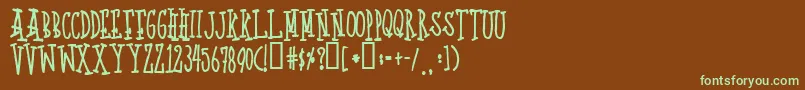 フォントQuoted – 緑色の文字が茶色の背景にあります。