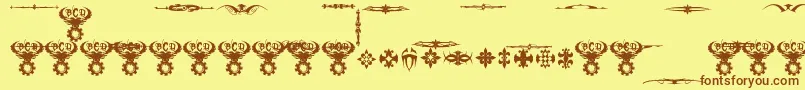 フォントMarquisDeSadeOrnaments – 茶色の文字が黄色の背景にあります。