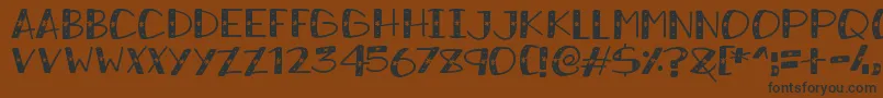 フォントSnowySparkles – 黒い文字が茶色の背景にあります