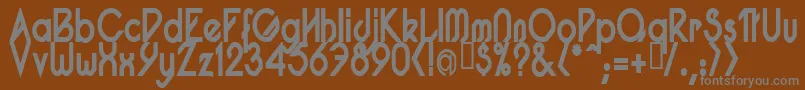 PacotillNarrowBod-fontti – harmaat kirjasimet ruskealla taustalla