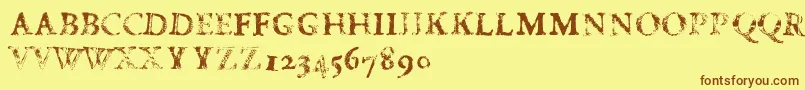 フォントFdCarimboh – 茶色の文字が黄色の背景にあります。