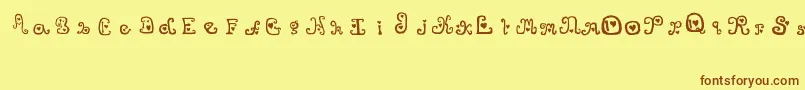 フォントThatsAmore – 茶色の文字が黄色の背景にあります。