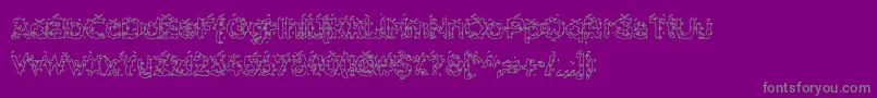 HammeroidHollow-fontti – harmaat kirjasimet violetilla taustalla