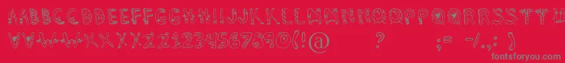 Dennealiens-fontti – harmaat kirjasimet punaisella taustalla