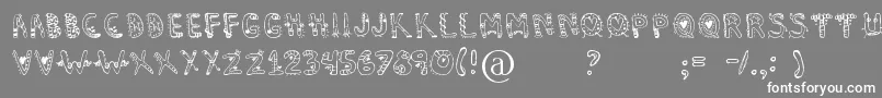 フォントDennealiens – 灰色の背景に白い文字