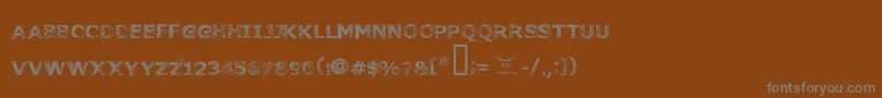 Fonttoachainsaw-Schriftart – Graue Schriften auf braunem Hintergrund
