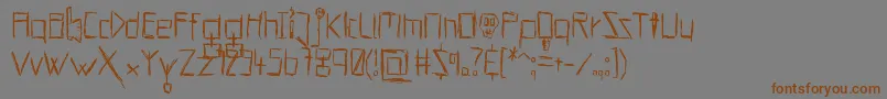 フォントHellsKittchenDevilGodBold – 茶色の文字が灰色の背景にあります。