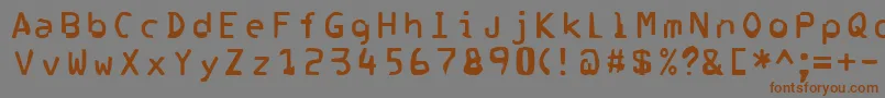 フォントCorrupter – 茶色の文字が灰色の背景にあります。