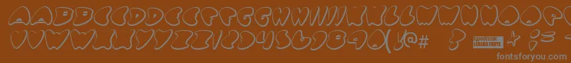 Gotnohea-fontti – harmaat kirjasimet ruskealla taustalla