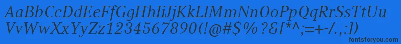 CompatilTextLtComItalic-Schriftart – Schwarze Schriften auf blauem Hintergrund