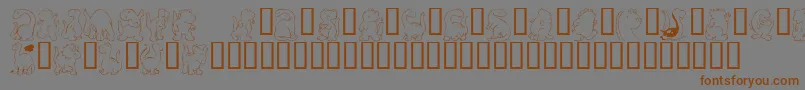 フォントKr Nickys Dinos – 茶色の文字が灰色の背景にあります。