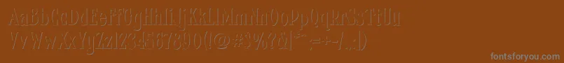 Fhacondfrenchshadenc-Schriftart – Graue Schriften auf braunem Hintergrund