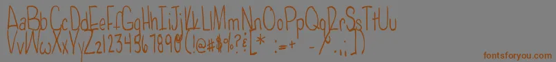 フォントPoisonedapples – 茶色の文字が灰色の背景にあります。
