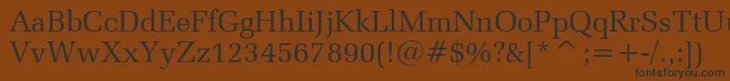 フォントZapfelliptBtRoman – 黒い文字が茶色の背景にあります