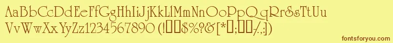 フォントAcademiassk – 茶色の文字が黄色の背景にあります。