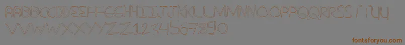 フォントNuevostencilHollow – 茶色の文字が灰色の背景にあります。