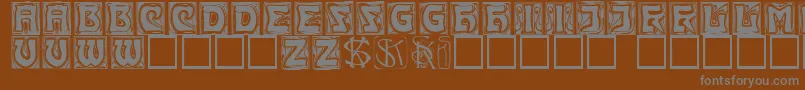 Kinigsteincaps-fontti – harmaat kirjasimet ruskealla taustalla