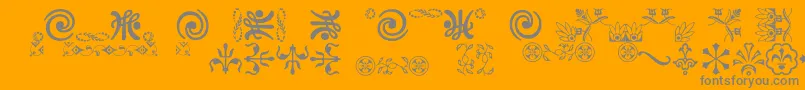 Ornamentsvillage-Schriftart – Graue Schriften auf orangefarbenem Hintergrund