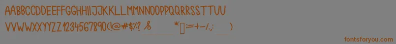 フォントChokoshtroko – 茶色の文字が灰色の背景にあります。