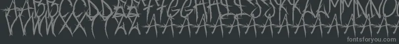 Brushofanarchyoutline-fontti – harmaat kirjasimet mustalla taustalla