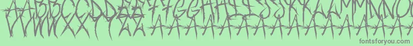 Czcionka Brushofanarchyoutline – szare czcionki na zielonym tle