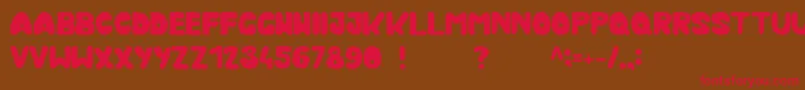 フォントKmurka – 赤い文字が茶色の背景にあります。