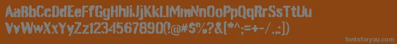 BurnabystencilRegular-fontti – harmaat kirjasimet ruskealla taustalla