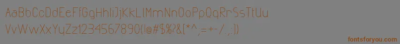 フォントExactaMedium – 茶色の文字が灰色の背景にあります。