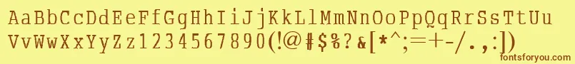 フォントAbcTypewriterrussian – 茶色の文字が黄色の背景にあります。