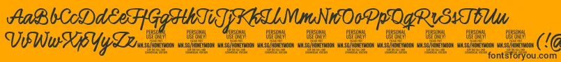 Czcionka HoneymoonupboldPersonal – czarne czcionki na pomarańczowym tle